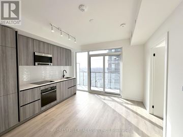 Toronto (Mount Pleasant East) condo for rent - A modern kitchen with wooden cabinets and stainless steel appliances.