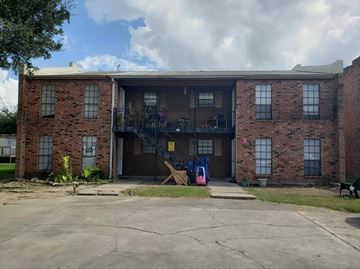 Lafayette apartment for rent - A brick building with a garage door open.