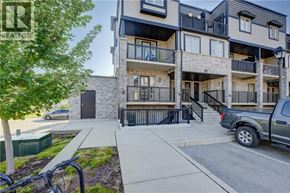 Kitchener townhouse for rent - A modern apartment building with a bicycle parked in front.