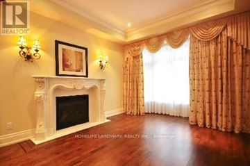 Toronto (Willowdale East) apartment for rent - A living room with a fireplace and a painting on the wall.