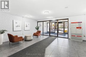 London East (East F) condo for rent - A real estate brokerage office with a white brick wall and a glass door.