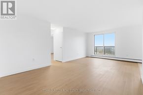 London East (East F) condo for rent - A white room with a window and wooden flooring.