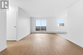 London East (East F) condo for rent - A large empty room with wooden floors and white walls.