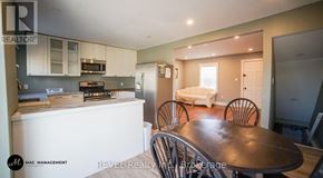 St. Catharines (Downtown) apartment for rent - A dining room with a table and chairs is shown.