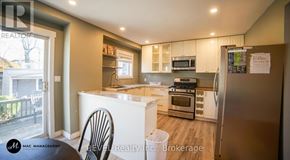 St. Catharines (Downtown) apartment for rent - A kitchen with a refrigerator, oven, and microwave.