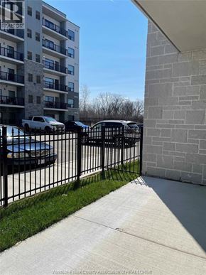 Windsor condo for rent - A white car is parked in front of a building.