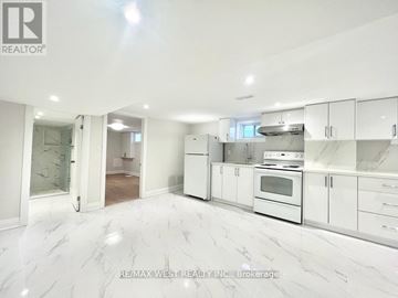 Toronto (Crescent Town) apartment for rent - A white kitchen with a marble floor and white cabinets.
