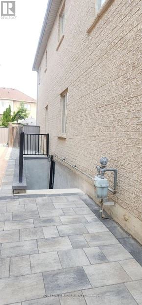 Vaughan apartment for rent - A brick wall with a gate and a water pipe.