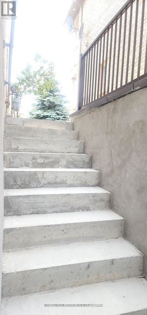 Vaughan apartment for rent - A set of concrete stairs with a metal railing on the right side.