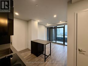 Vaughan (Concord) condo for rent - A room with a black table and a glass door leading outside.