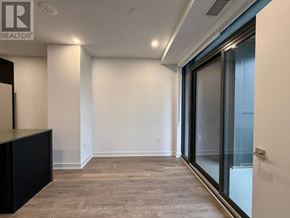 Vaughan (Concord) condo for rent - A room with a sliding glass door and a wooden floor.