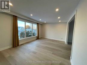 Barrie (Allandale Heights) apartment for rent - A spacious room with a large window and a view of the outdoors.