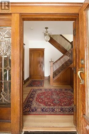 Hamilton (Blakeley) apartment for rent - A wooden door with a glass window and a rug in front of it.