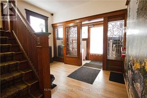 Hamilton (Blakeley) apartment for rent - A hallway with a staircase and a door with a glass panel.