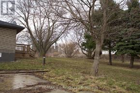 Woodstock (Woodstock - North) apartment for rent - A house with a brown roof and a sign that says RE/MAX a.b Realty Ltd Brokerage.