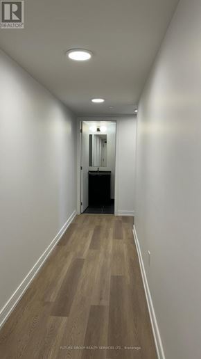Hamilton (Beasley) condo for rent - A long hallway with wood floors and white walls.