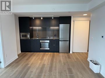 Hamilton (Beasley) condo for rent - A kitchen with black cabinets and stainless steel appliances.