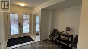 Welland (Dain City) townhouse for rent - A realtor's office with a glass door and a table with a lamp and a book on it.