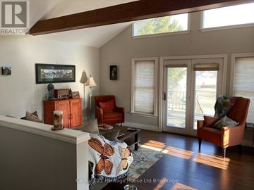 Tillsonburg apartment for rent - A living room with a couch, chair, and a painting on the wall.