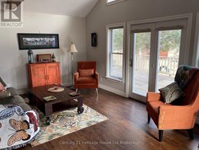 Tillsonburg apartment for rent - A living room with a wooden floor and a large window.