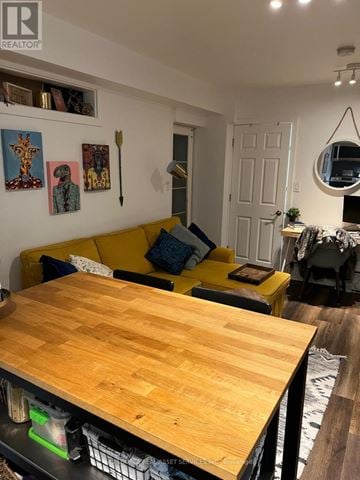 Toronto (Corso Italia-Davenport) fourplex for rent - A living room with a yellow couch and a wooden table.