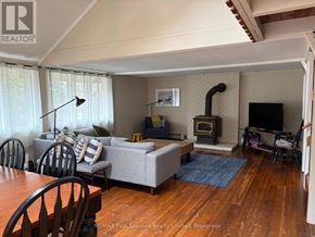Blue Mountains apartment for rent - A living room with a grey couch and a fireplace.