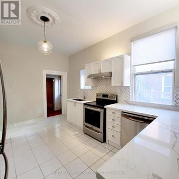 Hamilton (Stipley) multi-family for rent - A kitchen with white cabinets and appliances.