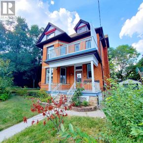 Hamilton (Stipley) multi-family for rent - A red brick house with a white porch.