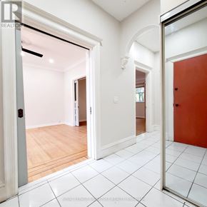 Hamilton (Stipley) multi-family for rent - A white hallway with a red door and a white tiled floor.