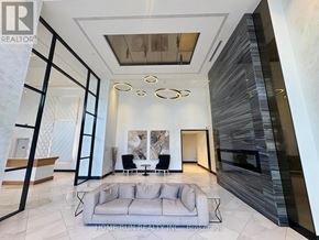 Ottawa condo for rent - A spacious living room with a grey sofa and a staircase with a marble design.