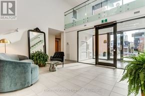Ottawa multi-family for rent - A modern office lobby with a glass wall and a green plant.