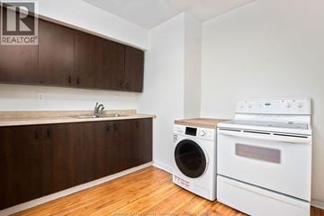 Windsor duplex for rent - A kitchen with a washer and dryer in it.