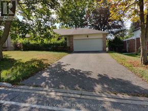 Markham (Bullock) apartment for rent - A driveway leads to a garage with a sign that says "REAL ONE REALTY INC., Brokerage.".