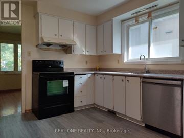 Markham (Bullock) apartment for rent - A kitchen with white cabinets and a black oven.