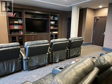 Markham (Unionville) condo for rent - A living room with a row of black leather chairs facing a television.