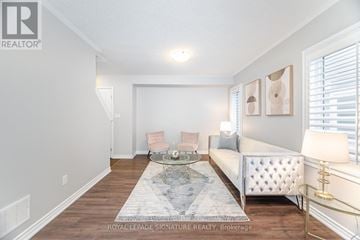 Kitchener house for rent - A living room with a white sofa and a coffee table.