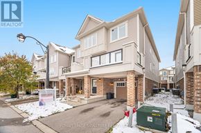 Kitchener house for rent - A large, modern house with a driveway in front and a sign that says "Royal LePage Signature Realty".
