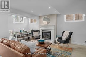 Pickering (Amberlea) apartment for rent - A living room with a fireplace and a brown leather couch.
