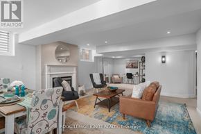 Pickering (Amberlea) apartment for rent - A living room with a fireplace and a dining table with chairs.