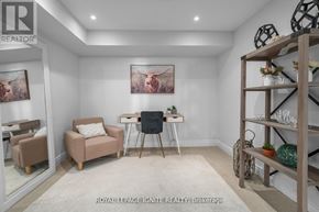 Pickering (Amberlea) apartment for rent - A living room with a chair, a table, and a painting on the wall.