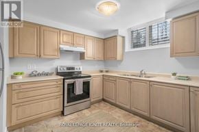 Pickering (Amberlea) apartment for rent - A kitchen with wooden cabinets and a stove top oven.