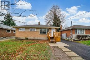 Guelph (St. George's) apartment for rent - A house with a brown brick exterior and a wooden front door.