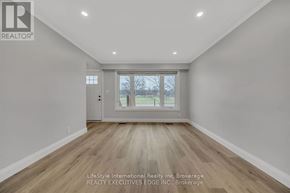 Guelph (St. George's) apartment for rent - A spacious room with wooden flooring and a large window.