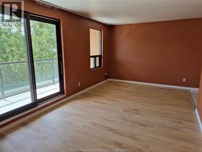 Windsor apartment for rent - A room with wooden flooring and a large window.