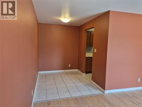 Windsor apartment for rent - A room with orange walls and a tiled floor.