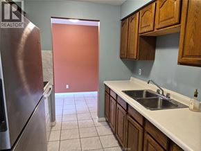 Windsor apartment for rent - A kitchen with a sink, refrigerator, and cabinets.