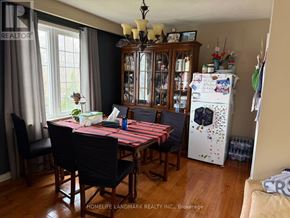 Toronto (Newtonbrook West) apartment for rent - A dining room with a table and chairs and a refrigerator with magnets on it.