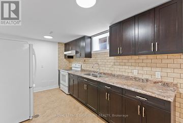 Toronto (Oakwood Village) apartment for rent - A kitchen with brown cabinets and a white refrigerator.