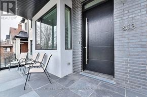Toronto (Caledonia-Fairbank) apartment for rent - A black door with a glass window is on a brick wall.