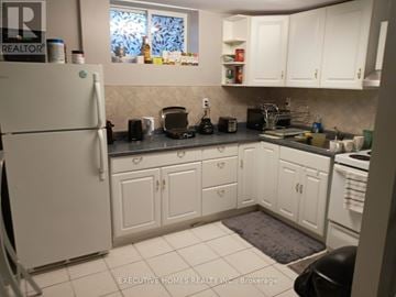 Mississauga (Lakeview) apartment for rent - A kitchen with white cabinets and appliances.